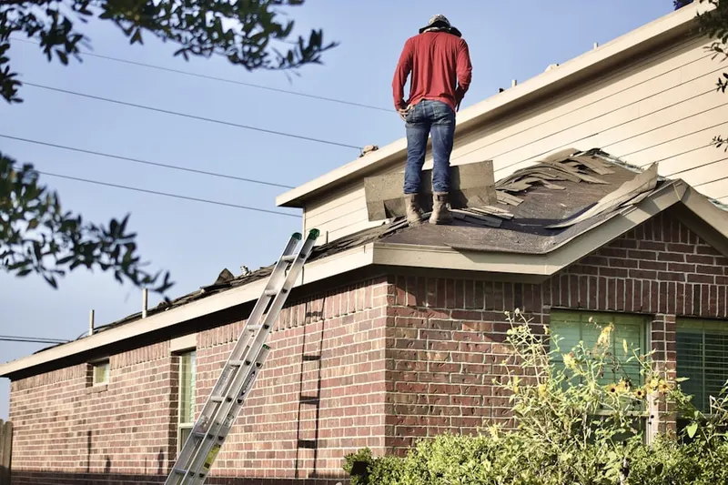 Professional roofer working on a residential roof in Meadow Mills